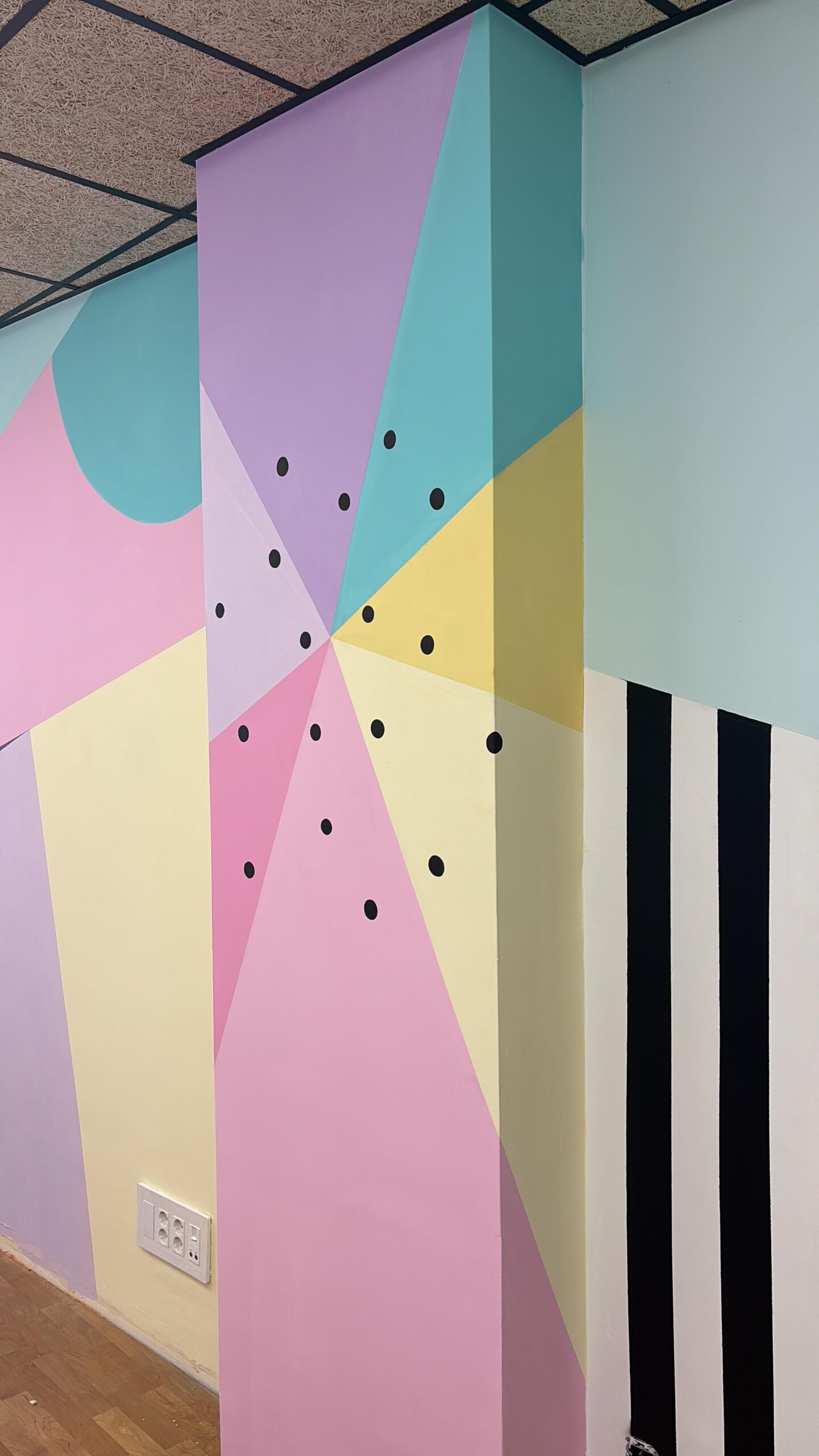Detalle del mural geométrico con rayas negras y blancas en el centro estético